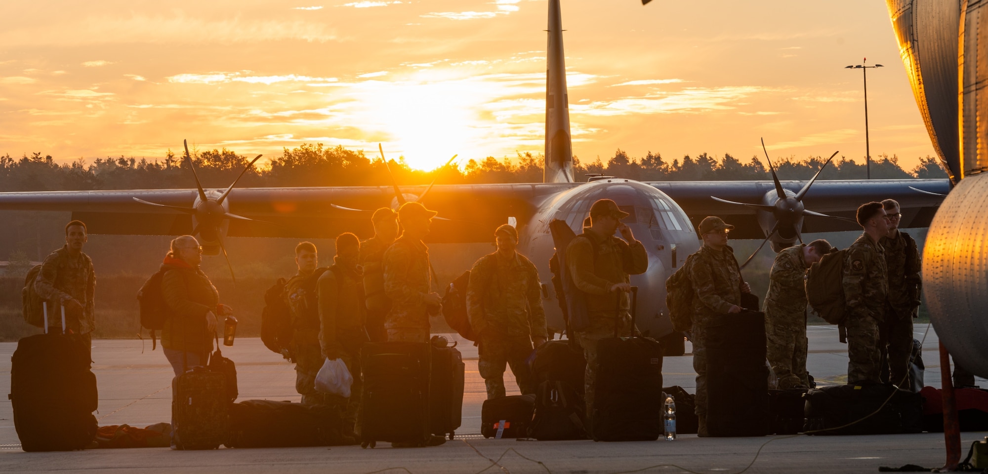 Airmen wait to board an aircraft.