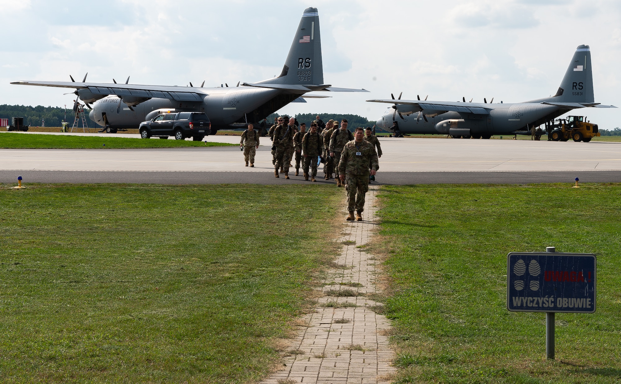 Airmen depart aircraft.
