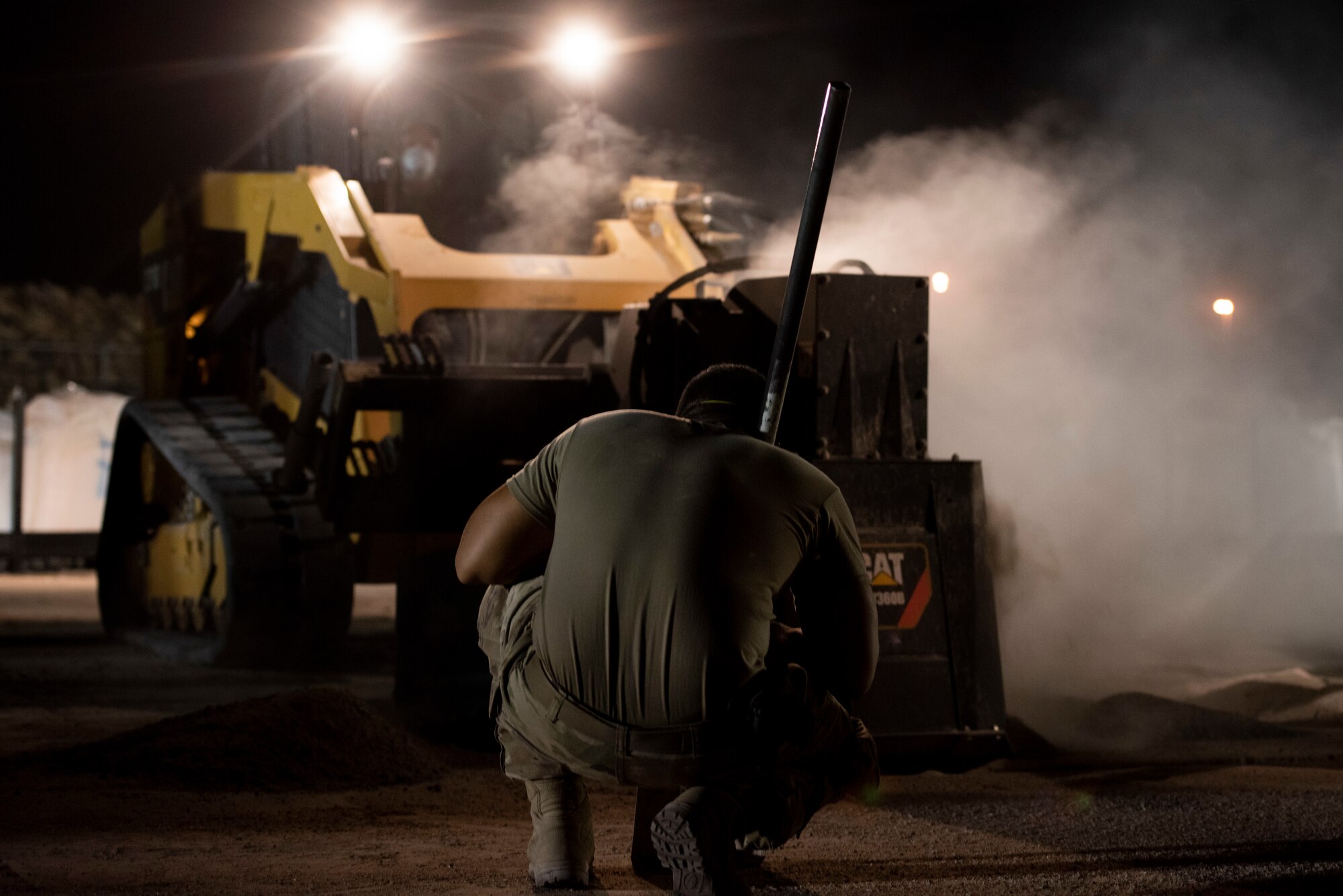 A photo of an Airman watching a wheel saw.