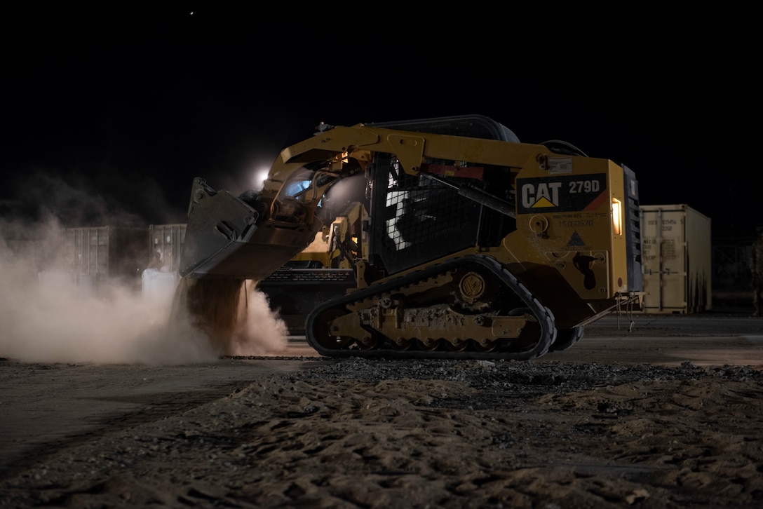 A photo of a bulldozer dumping sand