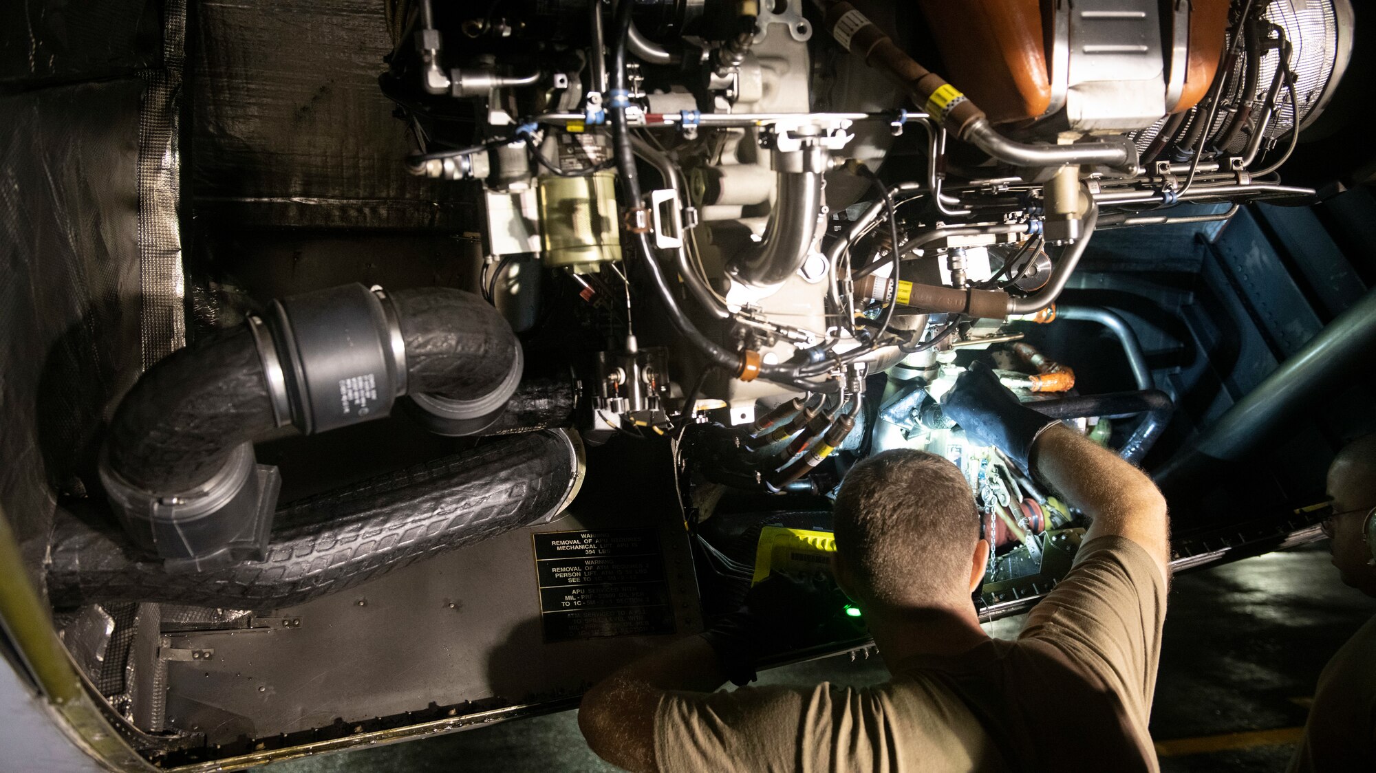 Staff Sgt. Brian Panas, 730th Air Mobility Squadron aircraft propulsion journeyman, checks a C-5M Super Galaxy air turbine motor prior to servicing at Yokota Air Base, Japan, Sept. 15, 2021. During this portion of a several day familiarization training, the 730th AMS replaced hydraulic fluid, provided a liquid nitrogen resupply and learned how to utilize a control panel for fuels. (U.S. Air Force photo by Staff Sgt. Joshua Edwards)