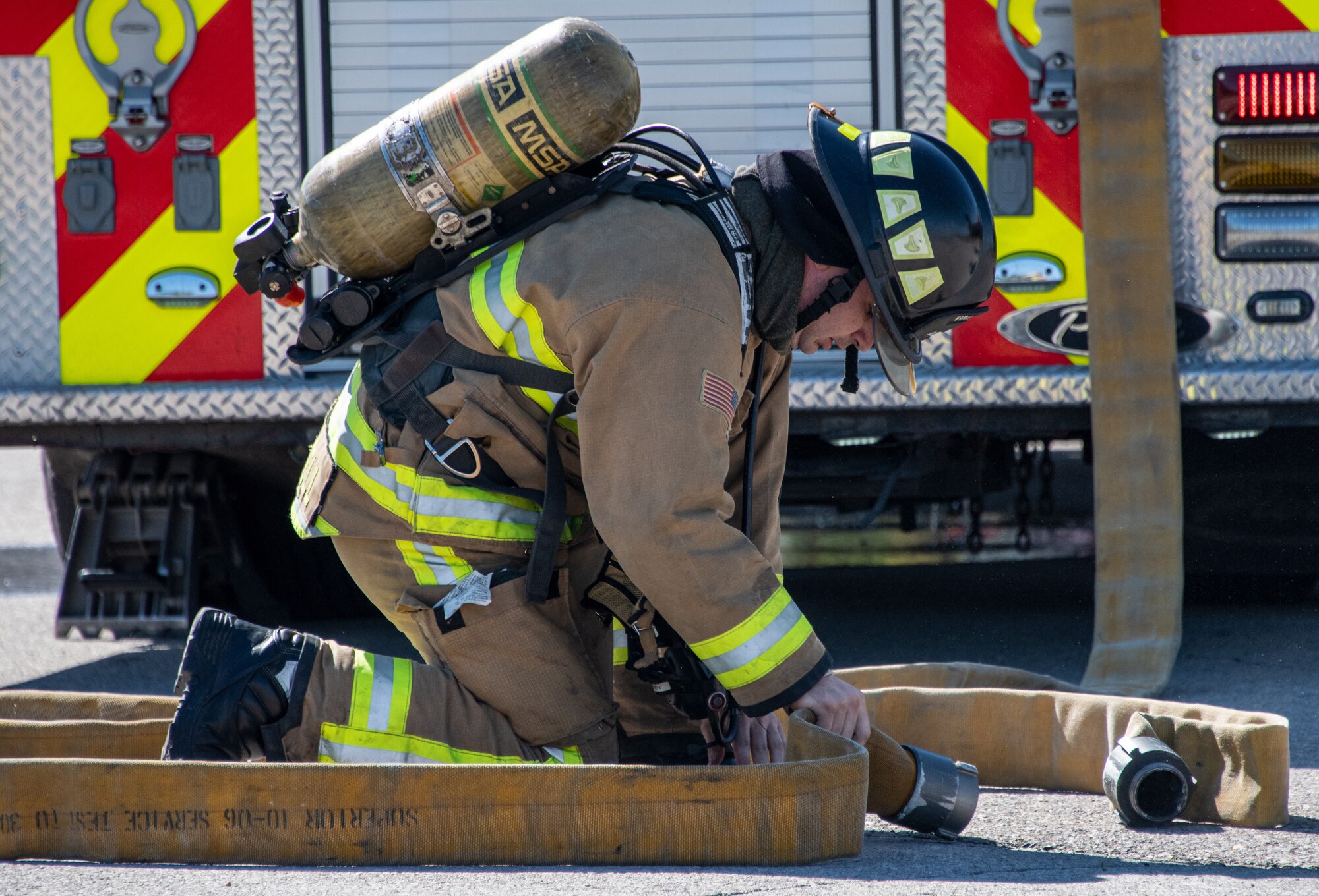 U.S. Air Force Staff Sgt. Colt Cottrell, firefighter with the 419th Civil Engineer Squadron, responds to a fire onboard a “downed aircraft” during a readiness training exercise