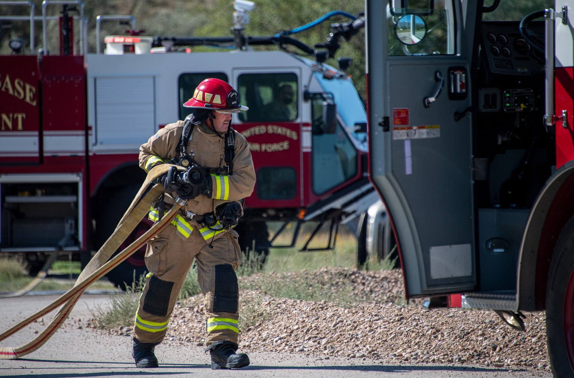 U.S. Air Force Tech. Sgt. Wyatt Matthews, firefighter in the 419th Civil Engineer Squadron, extinguishes a fire onboard a “downed aircraft” during a readiness training exercise