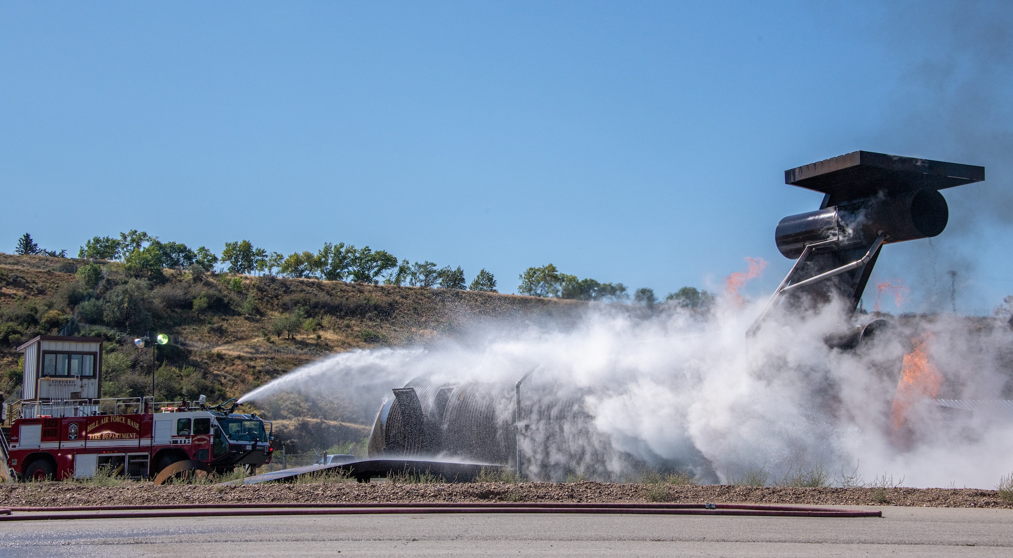 Firefighters from the 419th Civil Engineer Squadron extinguish the remnants of a fire during an aircraft live-burn at Hill Air Force Base