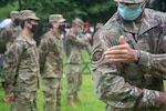 Virginia Air National Guard members from the 185th Cyberspace Operations Squadron ceremoniously removed their 185th COS bat patch, replacing it with the 856th Cyber Protection Team patch during send-off ceremonies Aug. 7, 2021, at Joint Base Langley-Eustis, Virginia.