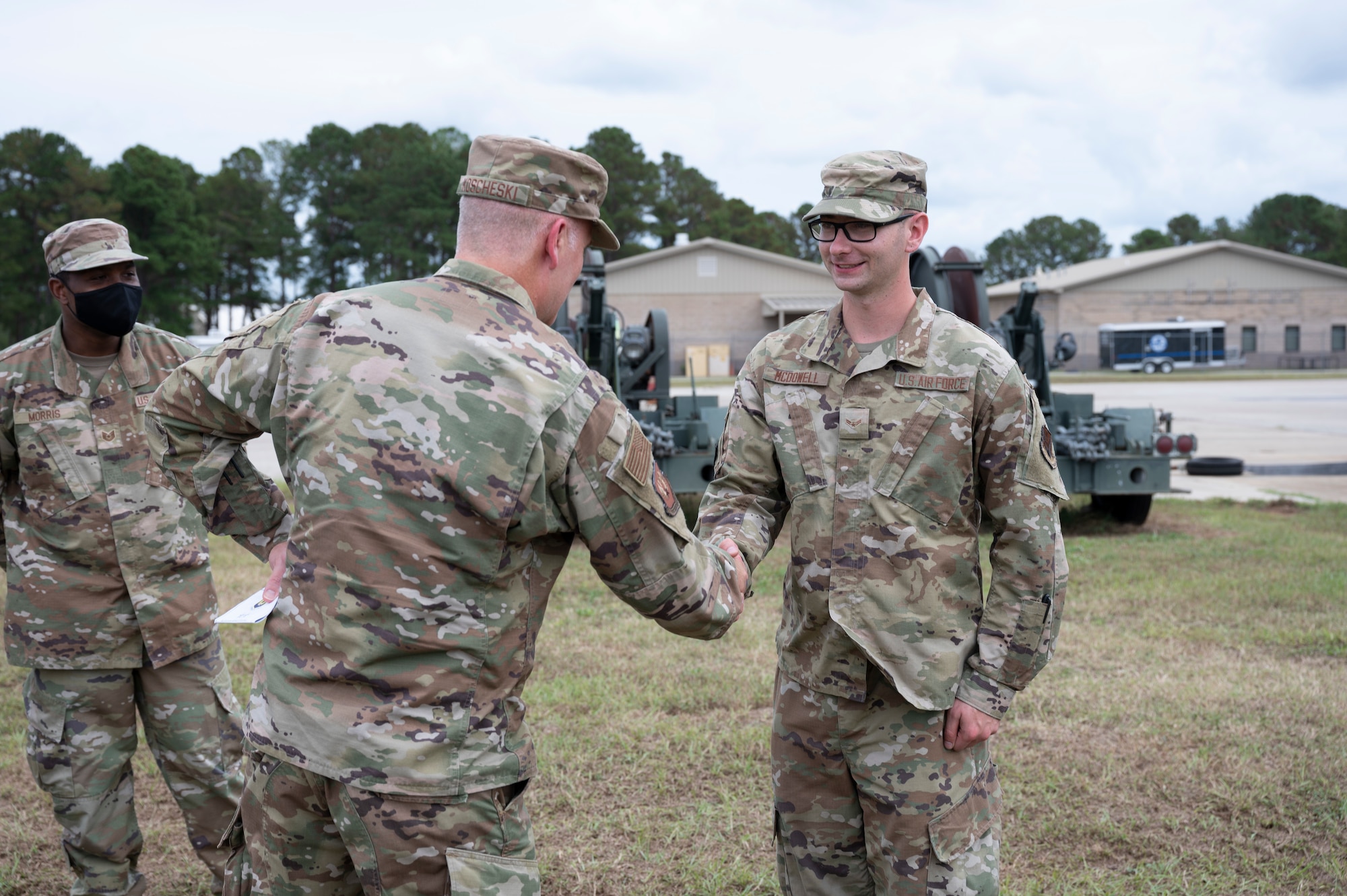 A photo of two Airmen shaking hands.