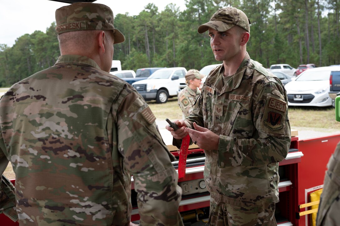 A photo of an Airman briefing another Airman.