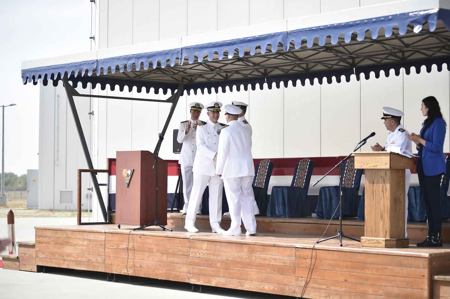 Cmdr. Michael Dwan, center left, shakes hands with Cmdr. Frederick Hettling, center right, after Cmdr. Hettling assumed command as Commander, U.S. Aegis Ashore Missile Defense System Romania (USAAMDSRO), at a change of command ceremony onboard Naval Support Facility Devesulu, Romania, Sept. 17.