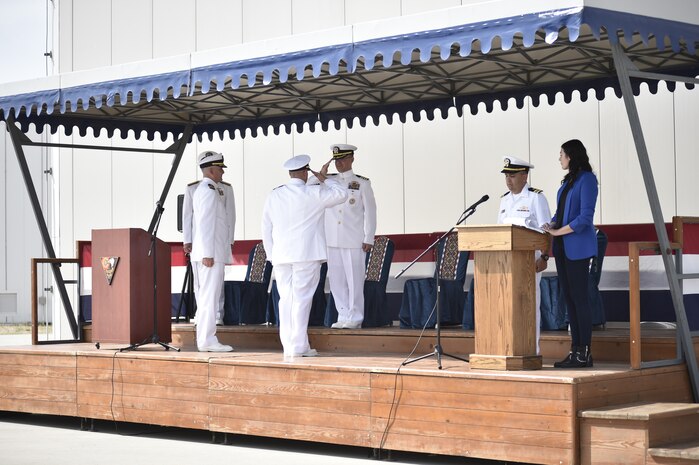 Cmdr. Mike Dwan, left, salutes Capt. Jonathan Lipps, commander, Task Force (CTF) 64, center, signifying that he has been relieved as Commander, U.S. Aegis Ashore Missile Defense System Romania (USAAMDSRO), at a change of command ceremony onboard Naval Support Facility Devesulu, Romania, Sept. 17.