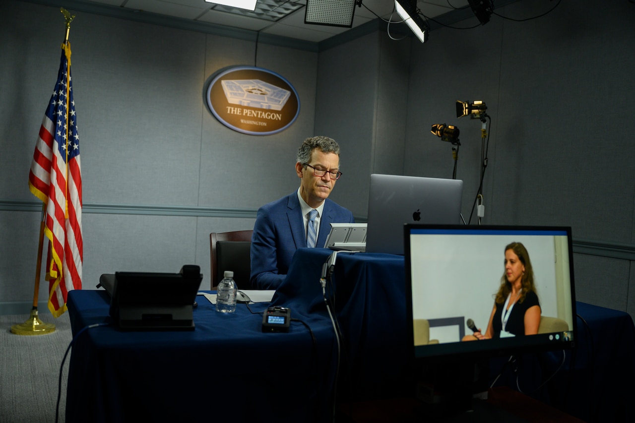 A man sits in front of a computer.