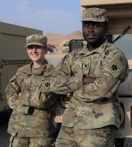 Spc. Stephen Ezenwosu and Pfc. Isadora Desrochers, medics with Headquarter Company, 1st Battalion 279th Infantry Regiment, 45th Infantry Brigade Combat Team, train at the National Training Center near Fort Irwin, CA, July 2021. Ezenwosu and Desrochers joined the OKNG on their path to become U.S. citizens. (Oklahoma Army National Guard photo by Spc. Caleb Stone)