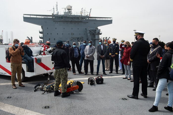 Airman Clarkjessieryl T. Francisco, second from left, discusses the Air Department's crash and salvage program aboard the Expeditionary Sea Base USS Hershel "Woody" Williams (ESB 4) during a tour of the ship for Namibian Navy leadership and U.S. embassy personnel, Sept. 17, 2021.