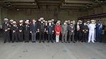 Lt. Cmdr. Ernique Sesler, executive officer, USS Hershel "Woody" Williams, fourth from left, Capt. Joseph Darlak, Military Sealift Command ship's master, fifth from left, Capt. Chad W. Graham, commanding officer, USS Hershel "Woody" Williams, sixth from left, Namibian Navy Rear Adm. Alweendo Paulus Amungulu, commander of the Namibian Navy, seventh from left, Jessica Long, chargé d’affaires, U.S. embassy in Namibia, eighth from left, Hon. Frans Kapofi, Namibian minister of defense, ninth from left, His Worship Trevino Forbes, mayor of Walvis Bay, tenth from left, and Namibian and U.S. Navy personnel pose for a photo following a reception aboard the Expeditionary Sea Base USS Hershel "Woody" Williams (ESB 4) pose for a photo with the Namibian Minister of Defense, Namibian Navy personnel, and U.S. embassy staff Sept. 17, 2021.