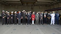 Lt. Cmdr. Ernique Sesler, executive officer, USS Hershel "Woody" Williams, fourth from left, Capt. Joseph Darlak, Military Sealift Command ship's master, fifth from left, Capt. Chad W. Graham, commanding officer, USS Hershel "Woody" Williams, sixth from left, Namibian Navy Rear Adm. Alweendo Paulus Amungulu, commander of the Namibian Navy, seventh from left, Jessica Long, chargé d’affaires, U.S. embassy in Namibia, eighth from left, Hon. Frans Kapofi, Namibian minister of defense, ninth from left, His Worship Trevino Forbes, mayor of Walvis Bay, tenth from left, and Namibian and U.S. Navy personnel pose for a photo following a reception aboard the Expeditionary Sea Base USS Hershel "Woody" Williams (ESB 4) pose for a photo with the Namibian Minister of Defense, Namibian Navy personnel, and U.S. embassy staff Sept. 17, 2021.