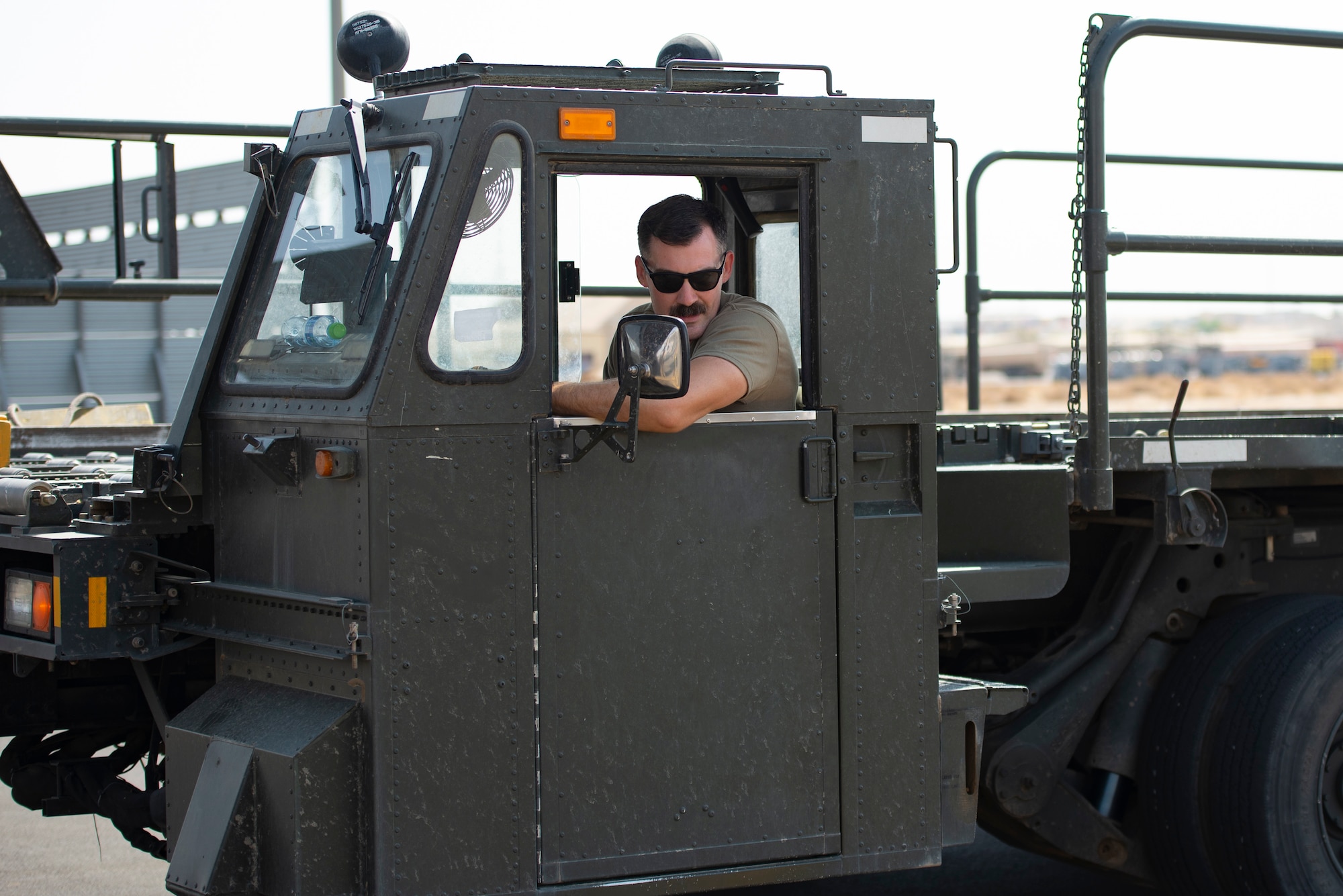 A photo of an Airman driving a loader