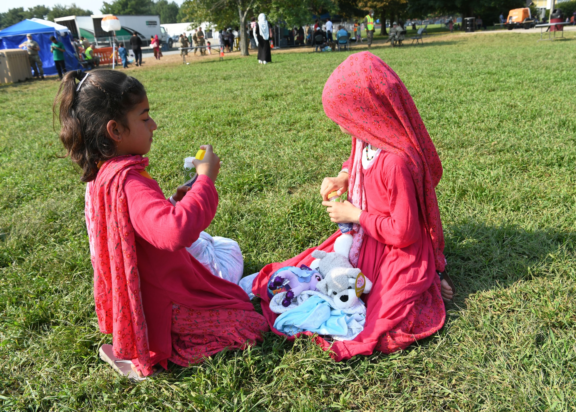 Two Afghan girls enjoy playtime together at Liberty Village, Joint Base McGuire-Dix-Lakehurst, New Jersey, Sept. 13, 2021.  The Department of Defense, through U.S. Northern Command, and in support of the Department of Homeland Security, is providing transportation, temporary housing, medical screening, and general support for at least 50,000 Afghan evacuees at suitable facilities, in permanent or temporary structures, as quickly as possible. This initiative provides Afghan personnel essential support at secure locations outside Afghanistan. (National Guard photo by Master Sgt. John Hughel, Washington Air National Guard)