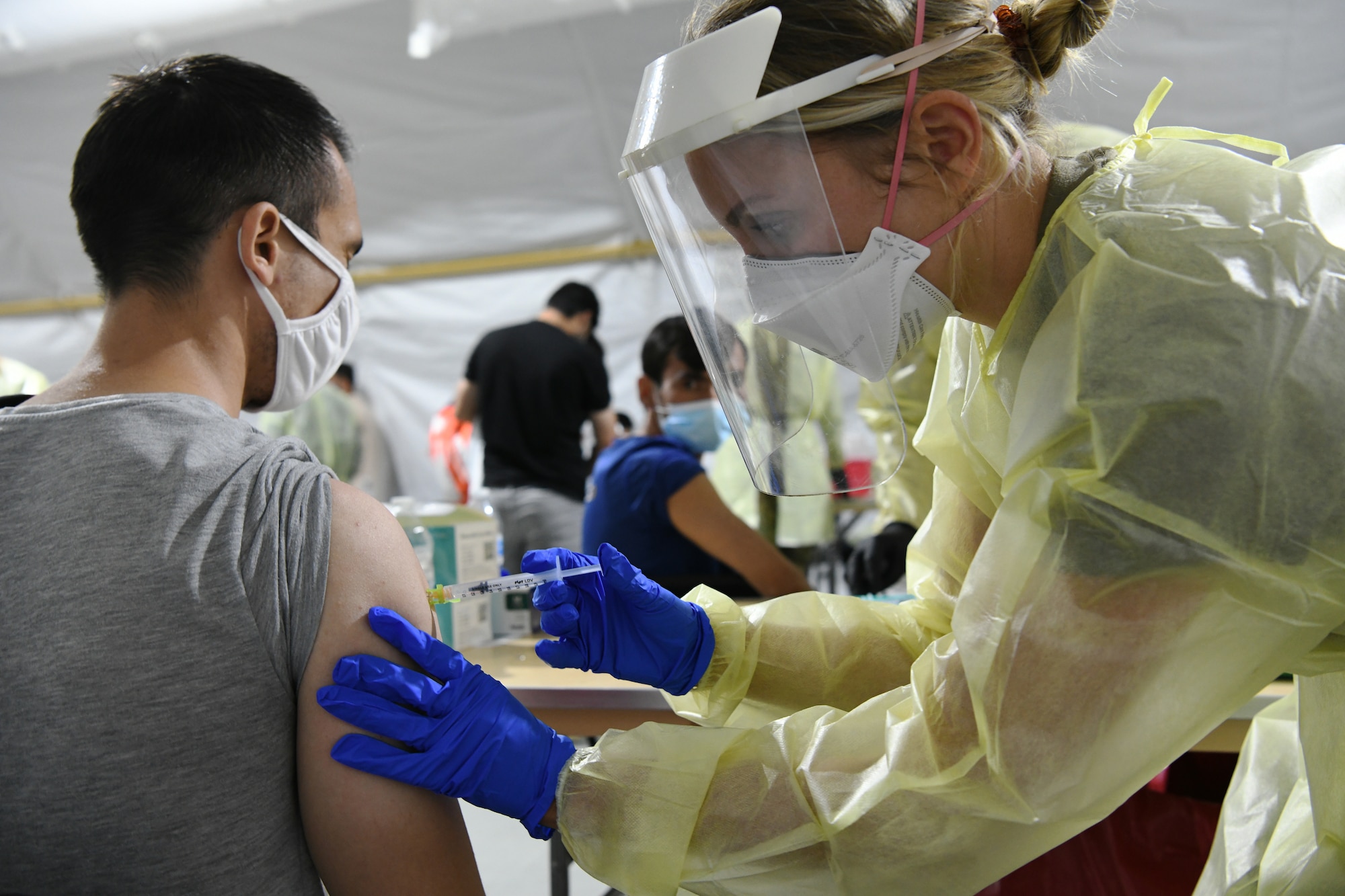 U.S. Air Force 1st Lt. Megan Busellato, assigned to the 445th Aeromedical Staging Squadron (ASTS), Wright-Patterson AFB, Dayton, Ohio, provides an immunization to an Afghan evacuee at Liberty Village, Joint Base McGuire-Dix-Lakehurst, New Jersey, Sept. 11, 2021.  The Department of Defense, through U.S. Northern Command, and in support of the Department of Homeland Security, is providing transportation, temporary housing, medical screening, and general support for at least 50,000 Afghan evacuees at suitable facilities, in permanent or temporary structures, as quickly as possible. This initiative provides Afghan personnel essential support at secure locations outside Afghanistan. (National Guard photo by Master Sgt. John Hughel, Washington Air National Guard)
