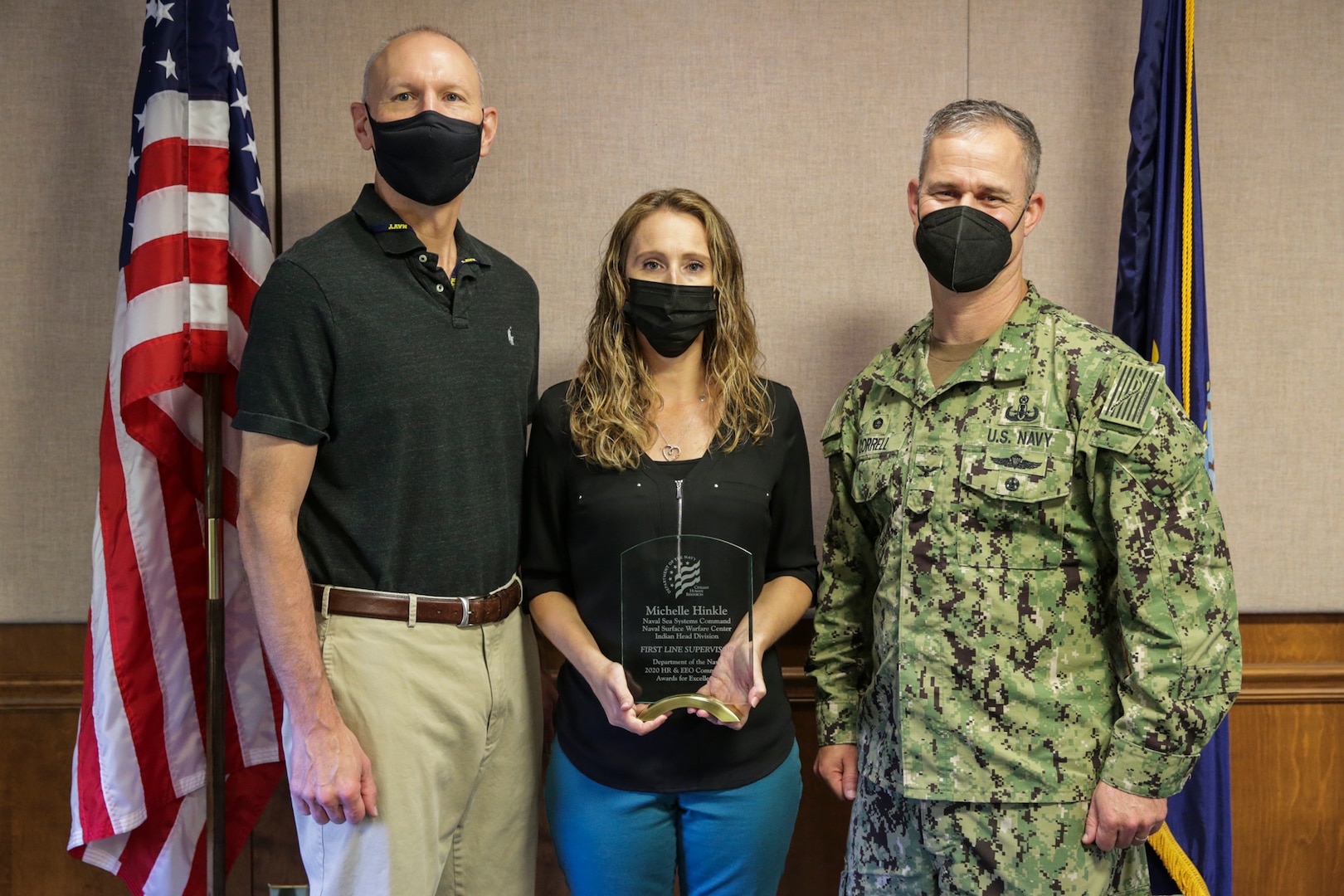 NSWC IHD employee Michelle Hinkle is presented the Department of Navy Human Resources and Equal Employment Opportunity Community Award for Excellence in the First Line Supervisor category by Technical Director Ashley Johnson and Commanding Officer Capt. Eric Correll on Sept. 14.