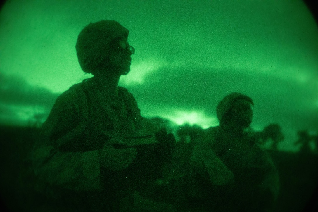 Two Marines are silhouetted against a green background.