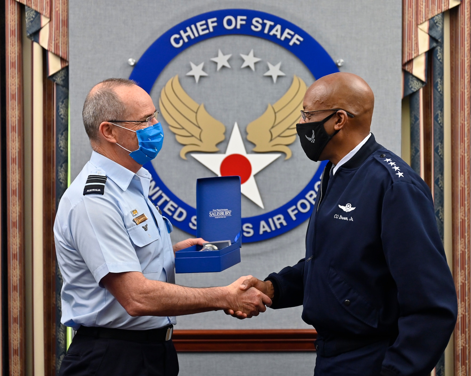 Air Force Chief of Staff Gen. CQ Brown, Jr., right, shakes hands with Air Marshal Melvin Hupfeld