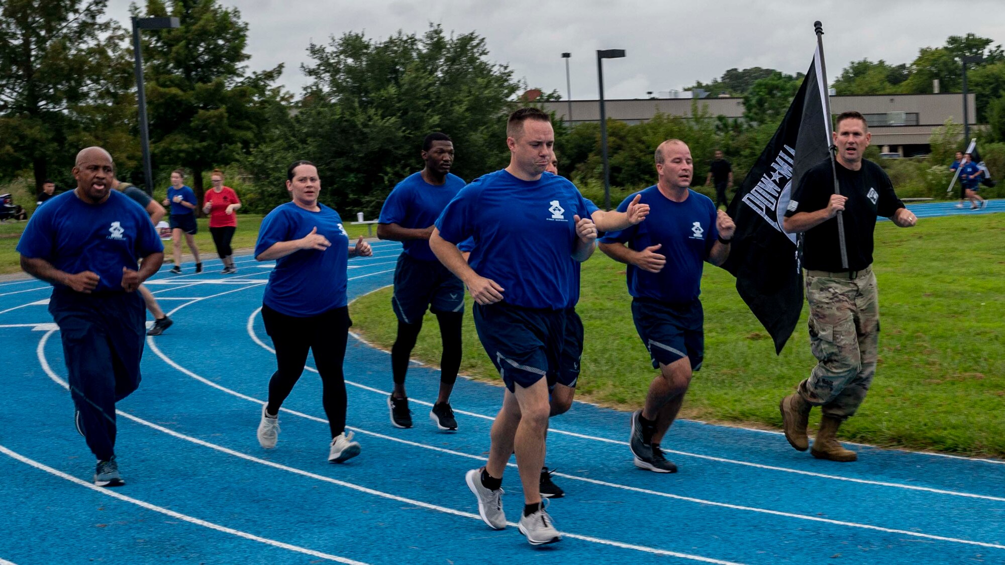 Col Beaulieu runs with the POW/MIA flag with the JBLE First Sergeants