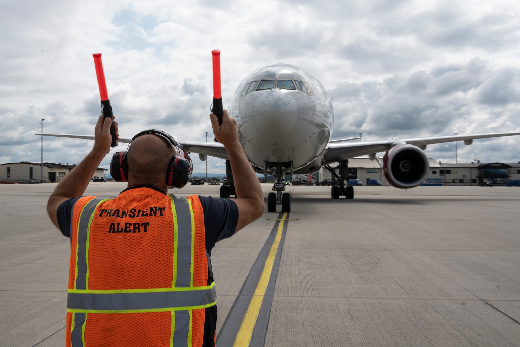Tim Mesecar, 52nd Maintenance Squadron Transit Alert assistant site manager, marshals a Patriot Express passenger jet on Spangdahlem Air Base, Germany, Aug. 23, 2021.