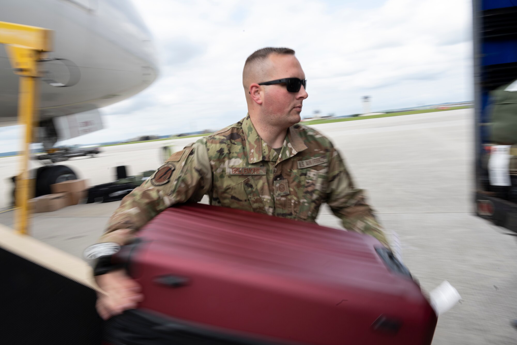 U.S. Air Force Master Sgt. Brett Bellemore, 52nd Logistics Readiness Squadron Air Transportation Function superintendent, offloads luggage from a Patriot Express passenger jet on Spangdahlem Air Base, Germany, Aug. 23, 2021.