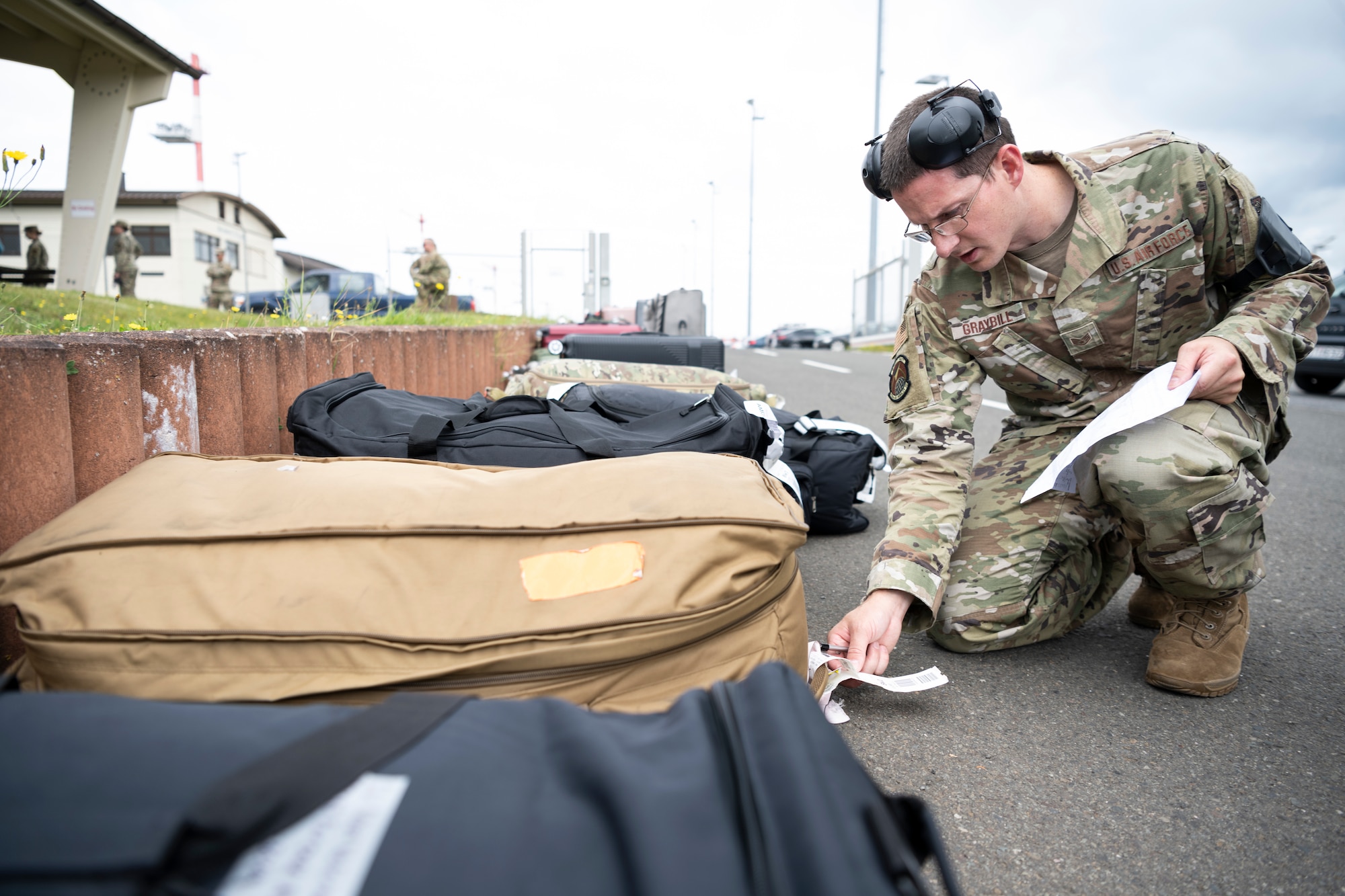 U.S. Air Force Staff Sgt. Christopher Graybill, 726th Air Mobility Squadron Air Terminal Operations Center controller, checks ID tags on passenger luggage on Spangdahlem Air Base, Germany, Aug. 23, 2021.
