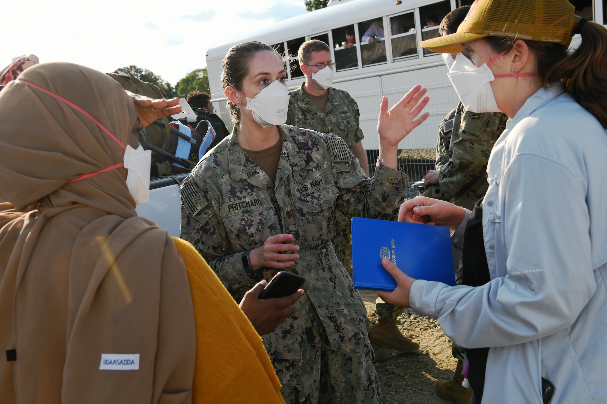 U.S. Navy Lt. Cmdr. Nikki Pritchard, (center) assigned to the Marine Corps Air Ground Combat Center, 29 Palms, San Bernardino, California, and Public Health Lead for Task Force Liberty, interacts with staff members preparing to open the new medical station Liberty Village, Joint Base McGuire-Dix-Lakehurst, New Jersey, Sept. 11, 2021.  The Department of Defense, through U.S. Northern Command, and in support of the Department of Homeland Security, is providing transportation, temporary housing, medical screening, and general support for at least 50,000 Afghan evacuees at suitable facilities, in permanent or temporary structures, as quickly as possible. This initiative provides Afghan personnel essential support at secure locations outside Afghanistan. (National Guard photo by Master Sgt. John Hughel, Washington Air National Guard)