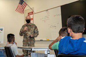 Brig. Gen. Matthew Higer, 412th Test Wing Commander, fields questions from 5th graders at Irving L. Branch Elementary School at the kick-off of the Math Tutoring Club on Edwards Air Force Base, California, Sept. 13. (Air Force photo by Katherine Franco)