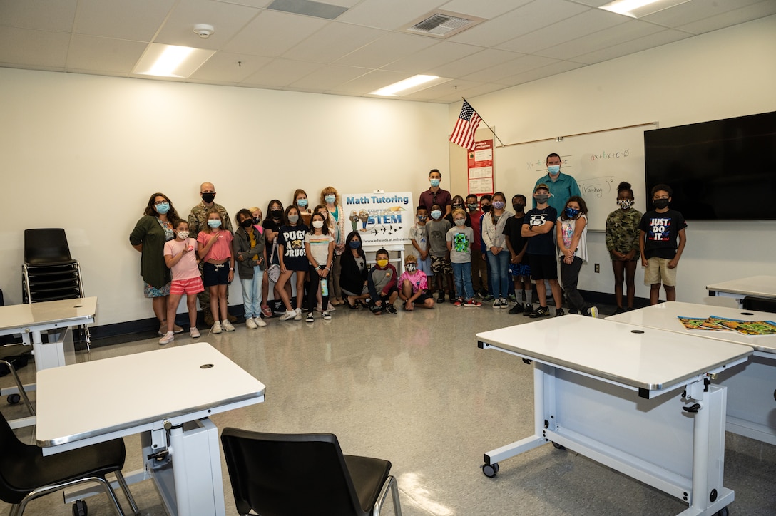 Brig. Gen. Matthew Higer, 412th Test Wing Commander, poses for a photo with teacher Julie Muniz's 5th grade class at Irving L. Branch Elementary School at the kick-off of the Math Tutoring Club on Edwards Air Force Base, California, Sept. 13. (Air Force photo by Katherine Franco)