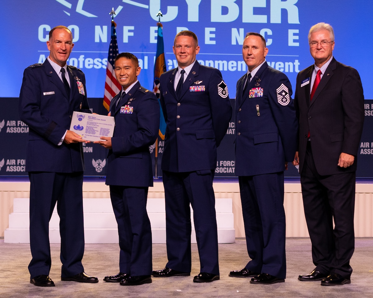 Maj. Gen. John Healy, deputy chief of Air Force Reserve, presents the Best Space Operations Crew Award to the 16th Expeditionary Space Control Flight Bravo, rotation 20-2, at the Air, Space & Cyber Conference at National Harbor, Maryland.