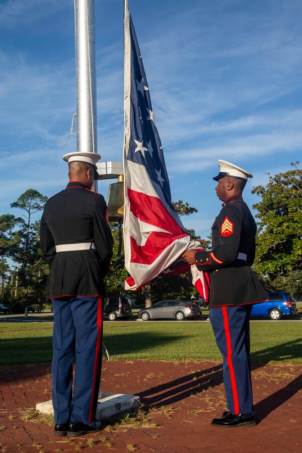 U.S. Marines with Headquarters Battalion, 2d Marine Division, raise the colors during a wreath laying ceremony on Camp Lejeune, N.C., Sept. 10, 2021.
