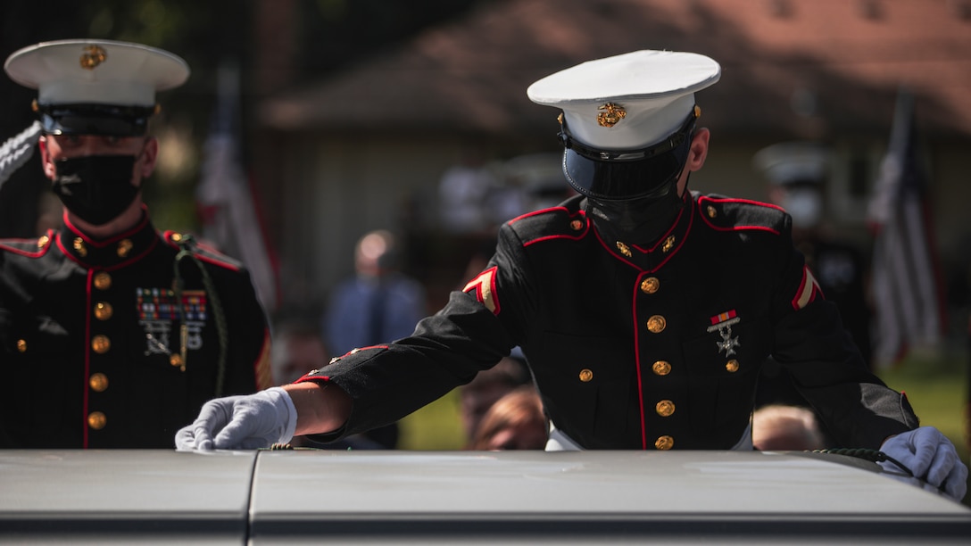 U.S. Marine Corps Pfc. Evan Luisi, a native Palmerton, Pa., and a rifleman with 1st Battalion, 6th Marine Regiment (1/6), 2d Marine Division, lays his French Fourragere on the casket of Pfc. Glenn White, in Emporia, Kan., Sept. 18, 2021. White was in 1/6 when he was killed in action in Tarawa Atoll, Gilbert Islands, during World War II. “Being able to participate in the ceremony was an amazing opportunity; laying down my French Fourragere was a huge honor,” Luisi said. “My French Fourragere will be buried with him, to symbolize our brotherhood through 1/6. Something that I once wore will always be a part of his memory—that’s incredible, I’ll always remember that moment.”