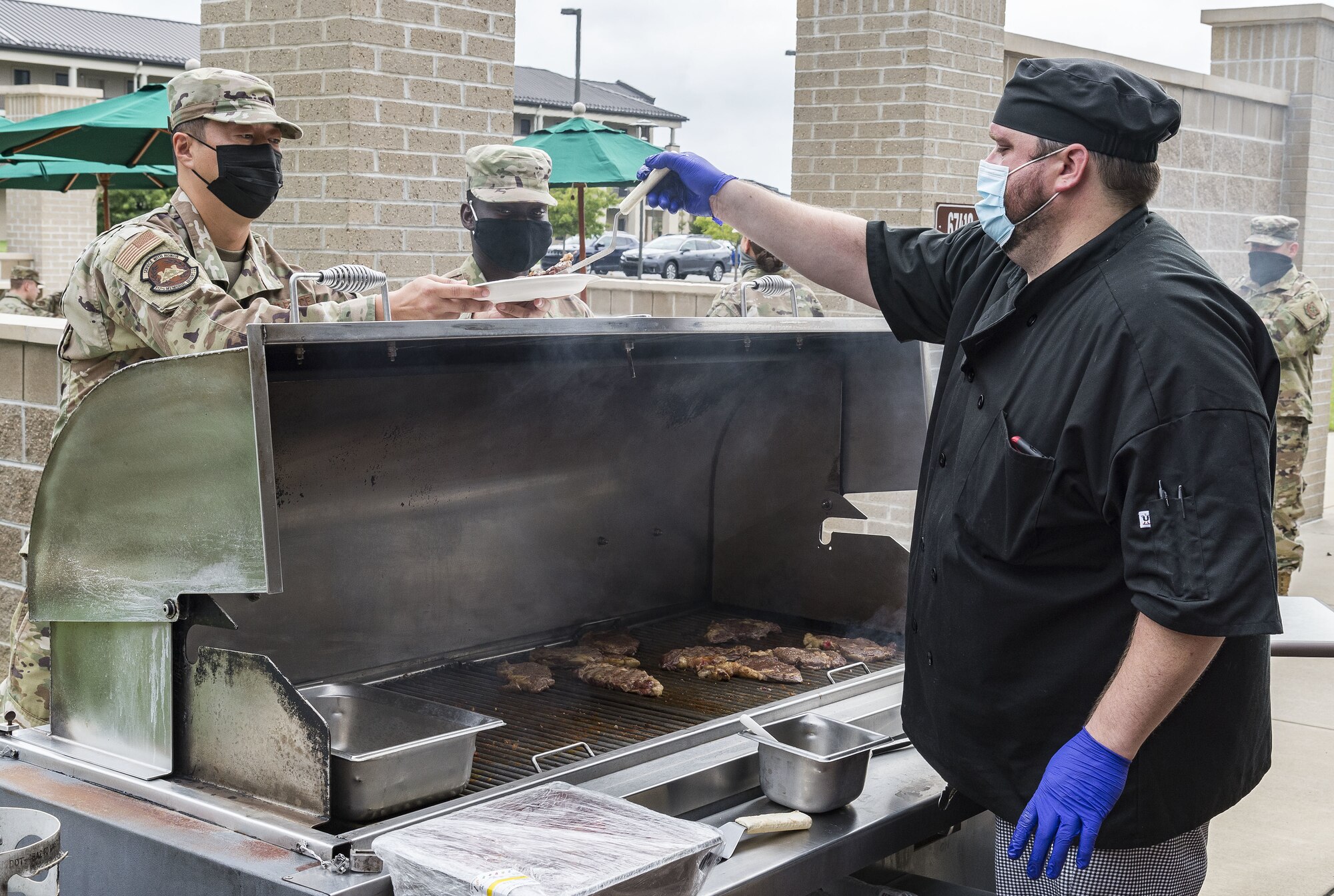 Mike Donze, Sodexo executive chef, serves steak to a Team Dover Airman at the Patterson Dining Facility on Dover Air Force Base, Delaware, Sept. 17, 2021. The DFAC held a picnic-style lunch commemorating the grand reopening, as well as a cake cutting celebrating the Air Force’s 74th birthday. (U.S. Air Force photo by Roland Balik)