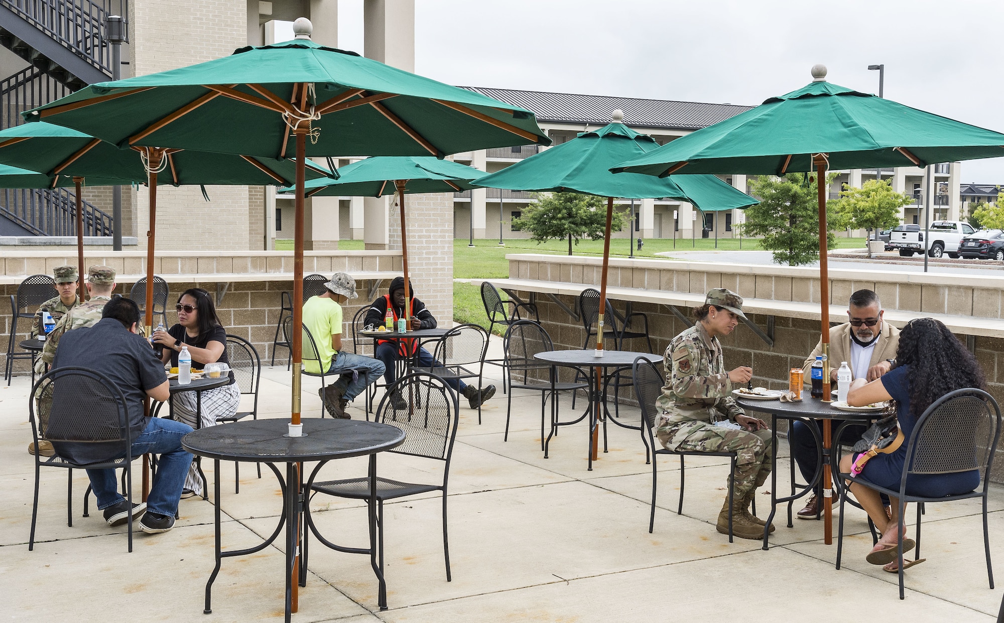 Team Dover members eat lunch outside the Patterson Dining Facility on Dover Air Force Base, Delaware, Sept. 17, 2021. The DFAC held a picnic-style lunch commemorating the grand reopening, as well as a cake cutting celebrating the Air Force's 74th birthday. (U.S. Air Force photo by Roland Balik)