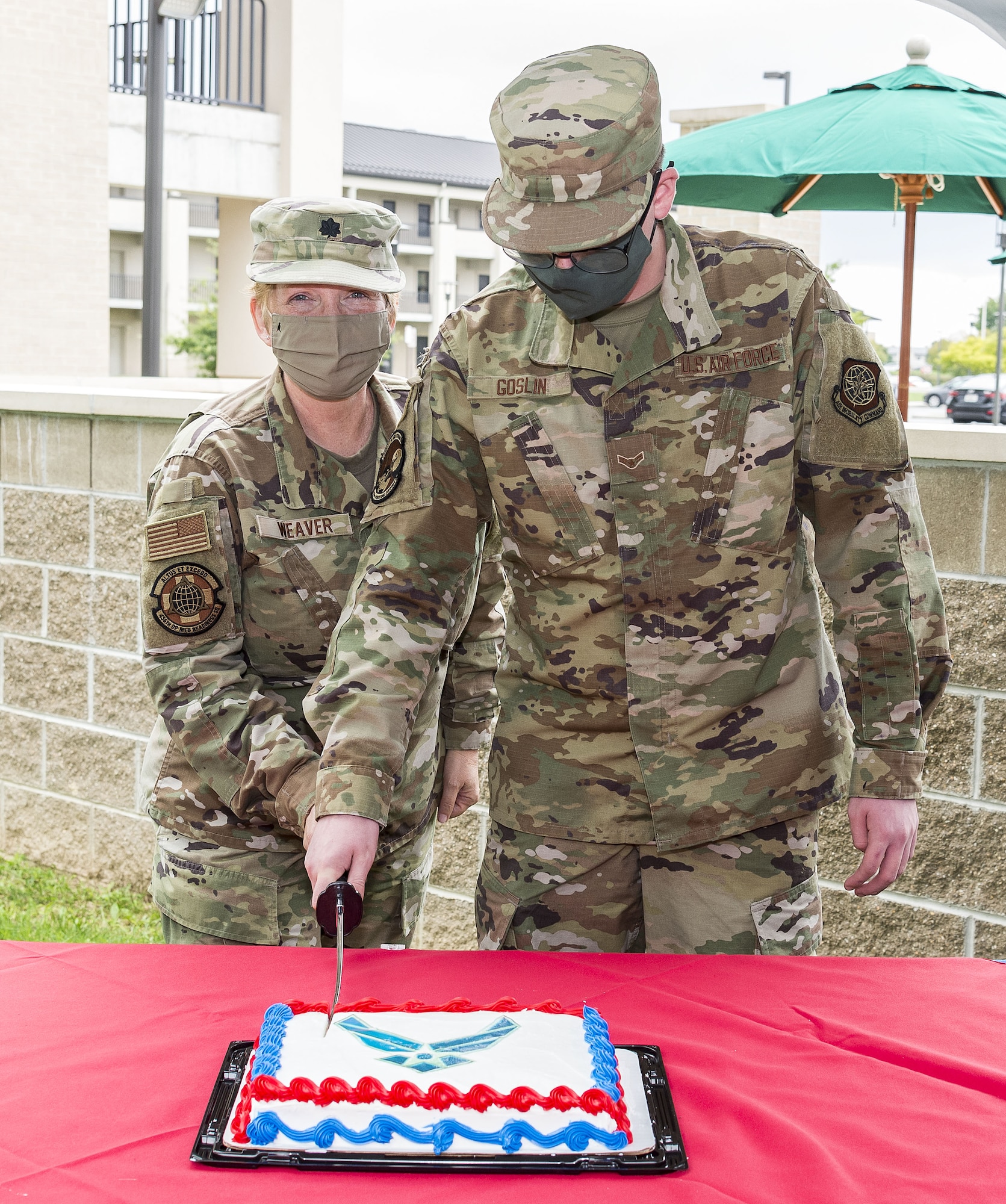 Lt. Col. Jessica Weaver, left, 436th Operational Medical Readiness Squadron dental flight commander, and Airman 1st Class John Goslin,  436th Operations Support Squadron air traffic control apprentice, cut a birthday cake at the Patterson Dining Facility on Dover Air Force Base, Delaware, Sept. 17, 2021. Weaver and Goslin represented the 436th Airlift Wing's oldest and youngest Airmen during the cake cutting celebrating the Air Force's 74th birthday. (U.S. Air Force photo by Roland Balik)