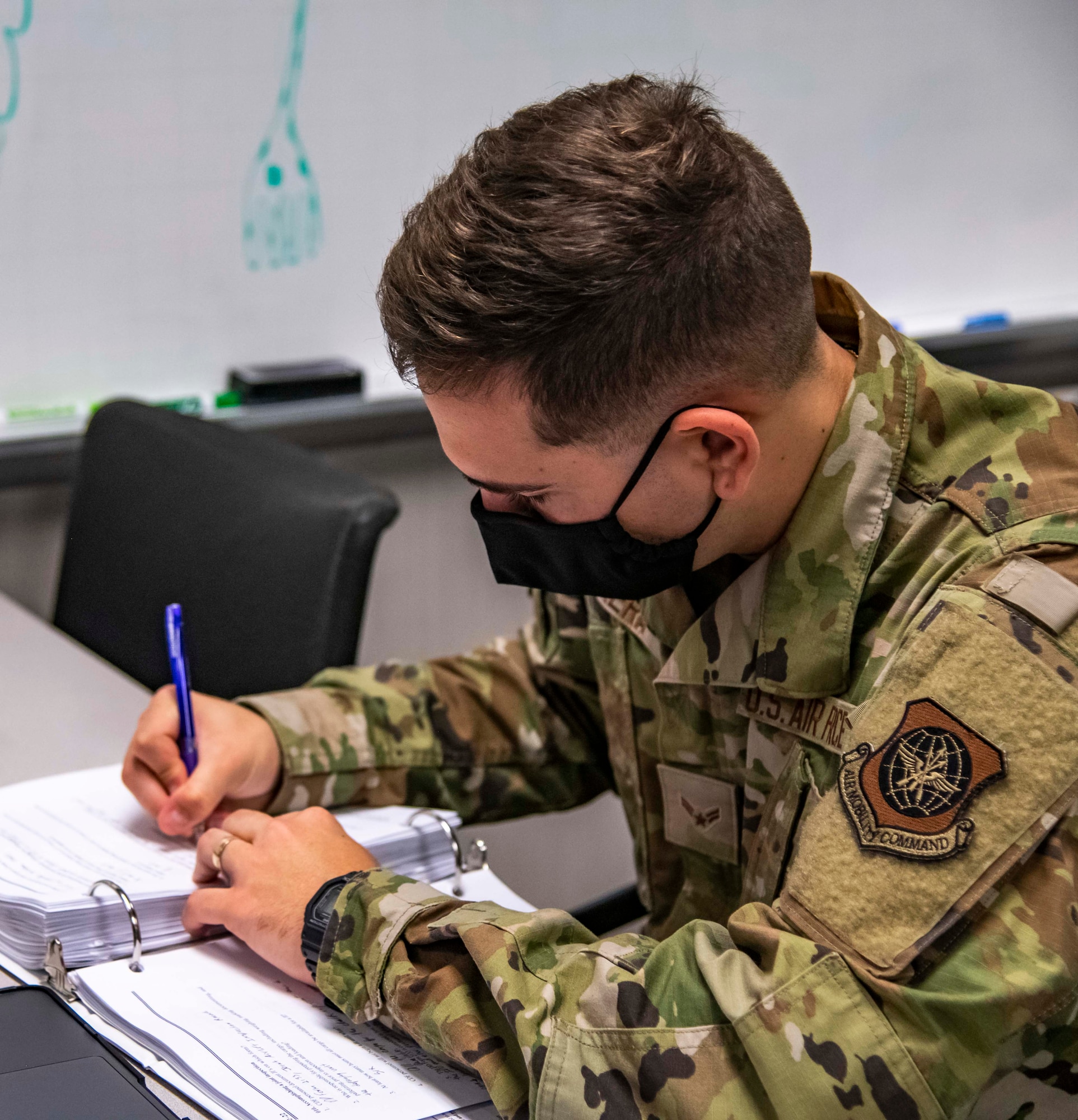 Airman 1st Class Julio Cesar Cabrera Romero, 436th Aerial Port Squadron passenger service agent trainee, studies learning materials at Dover Air Force Base, Delaware, Sept. 7, 2021. Cabrera is attending Port Dawg University, where he studies material on all of his respective work sections for upgrade training. (U.S. Air Force photo by Senior Airman Stephani Barge)