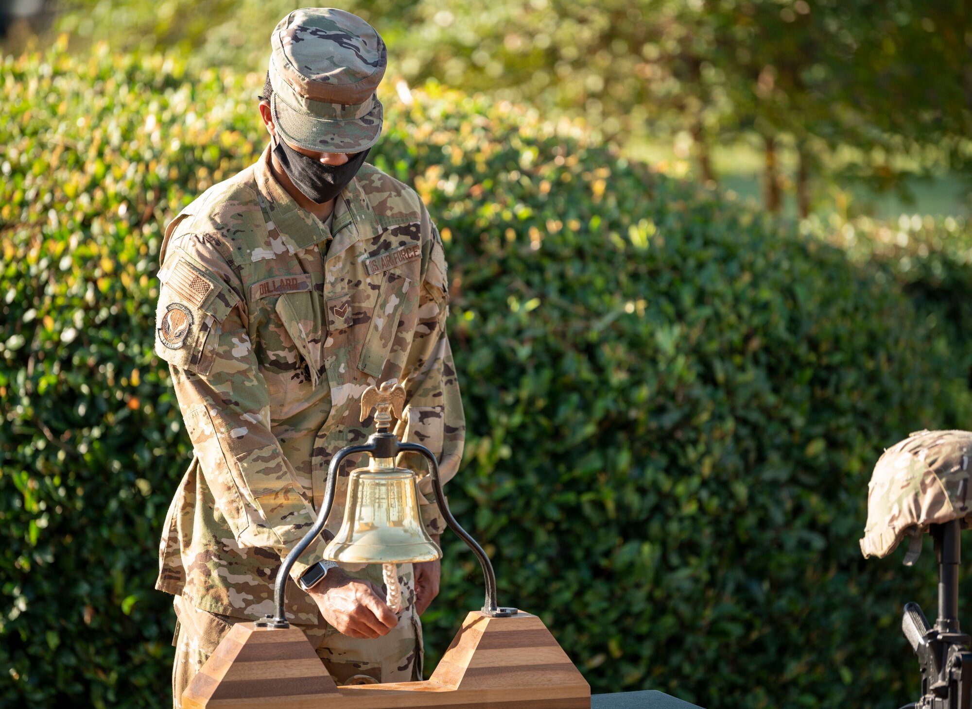 U.S. Air Force Senior Airman Marcus Dillard, a 1st Special Operations Civil Engineer Squadron firefighter, performs the bell ringing during a 9/11 Memorial Ruck Ceremony