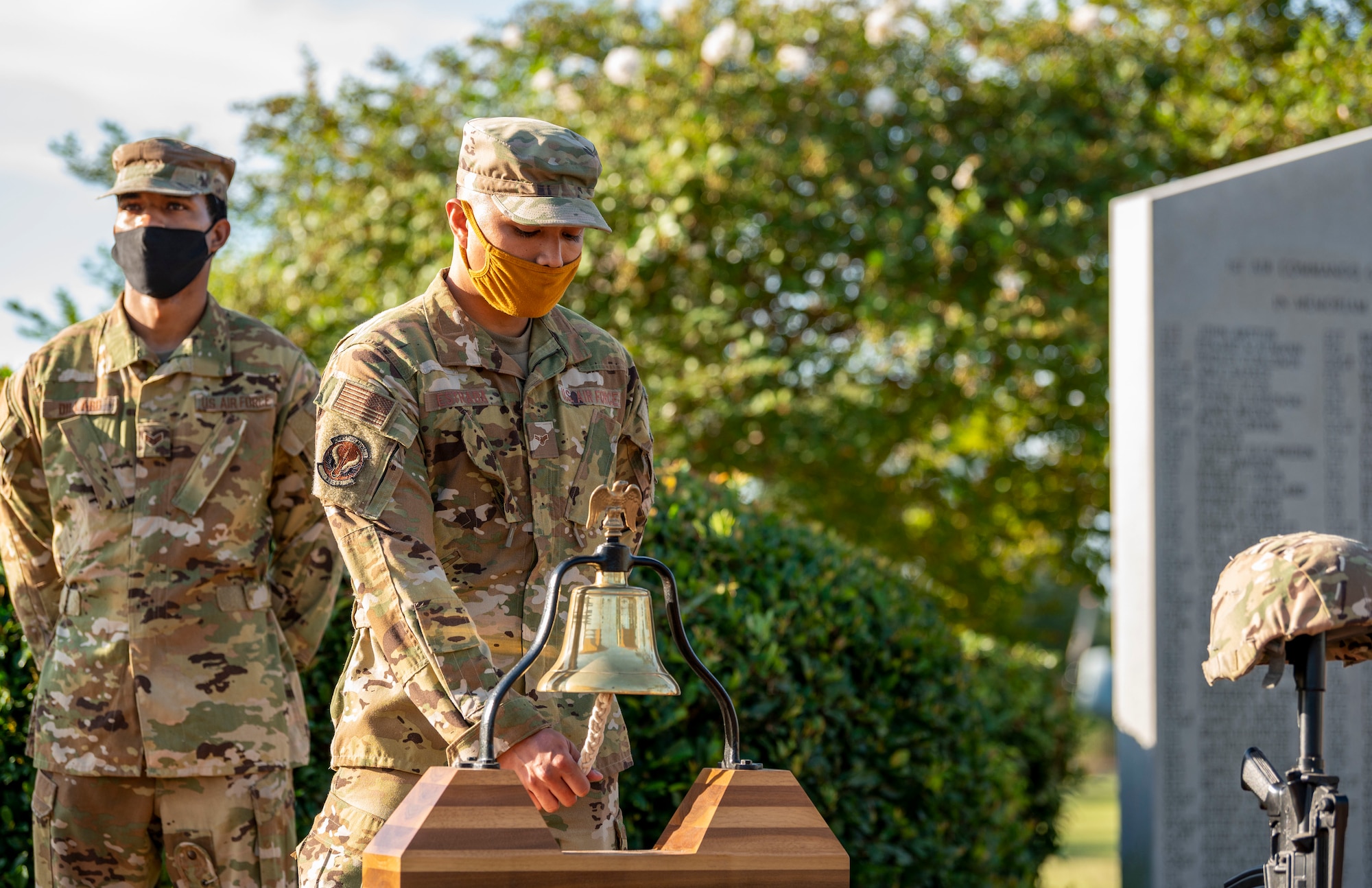 U.S. Air Force Airman 1st Class Angel Estrada, a 1st Special Operations Civil Engineer Squadron firefighter, performs the bell ringing during a 9/11 Memorial Ruck Ceremony