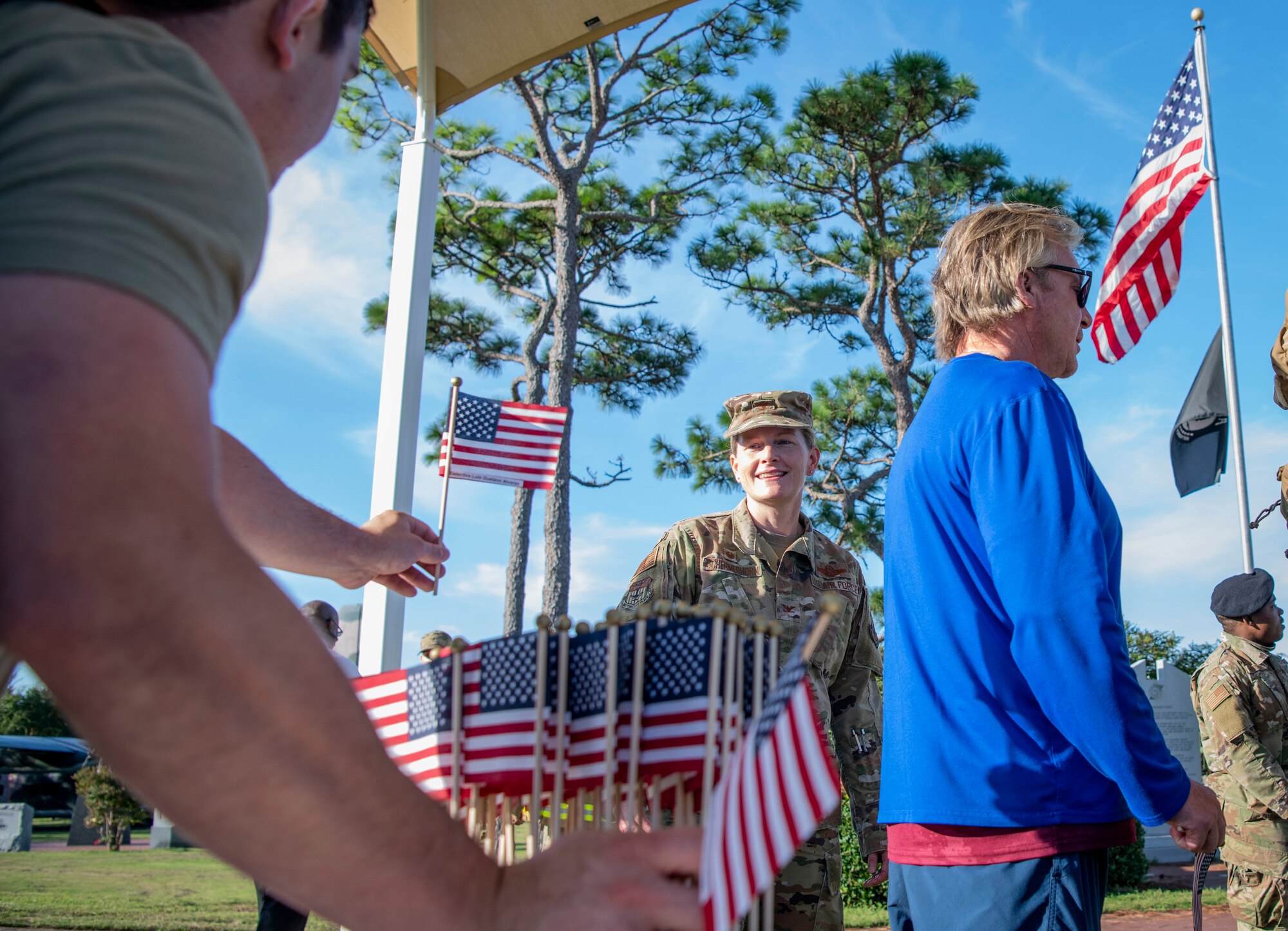 U.S. Air Force Col. Jocelyn Schermerhorn, 1st Special Operations Wing commander, grabs an American flag to take on a 9/11 Memorial Ruck