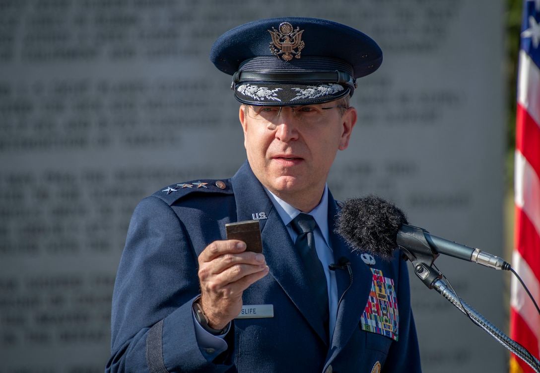 U.S. Air Force Lt. Gen. James Slife, Air Force Special Operations Command commander, holds a piece of the World Trade Center twin towers during a Hurlburt Field 9/11 Memorial Ceremony
