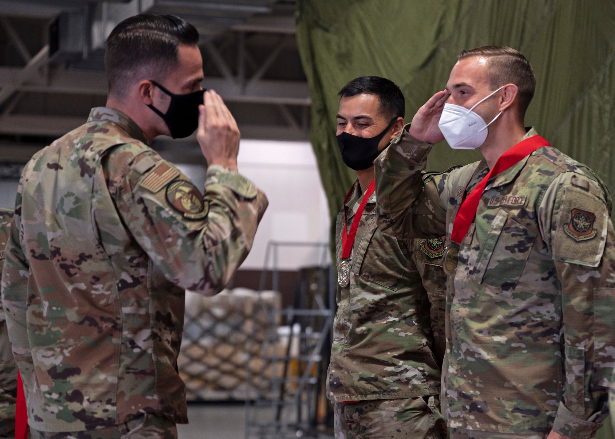 U.S. Air Force Maj. Wesley Ekwall, 62nd Aerial Port Squadron commander, presents a medal to Senior Airman Connor Dickson, air terminal operations center information controller with the 62nd APS, at Joint Base Lewis-McChord, Washington, Sept. 15, 2021. Dickson was one of six Airmen from the Eagle Port team to compete at 2021 Pacific Air Forces (PACAF) Port Dawg Rodeo in August; where the team brought home two first place event awards and the award for Top Port Dawg Team. (U.S. Air Force photo by Senior Airman Zoe Thacker)