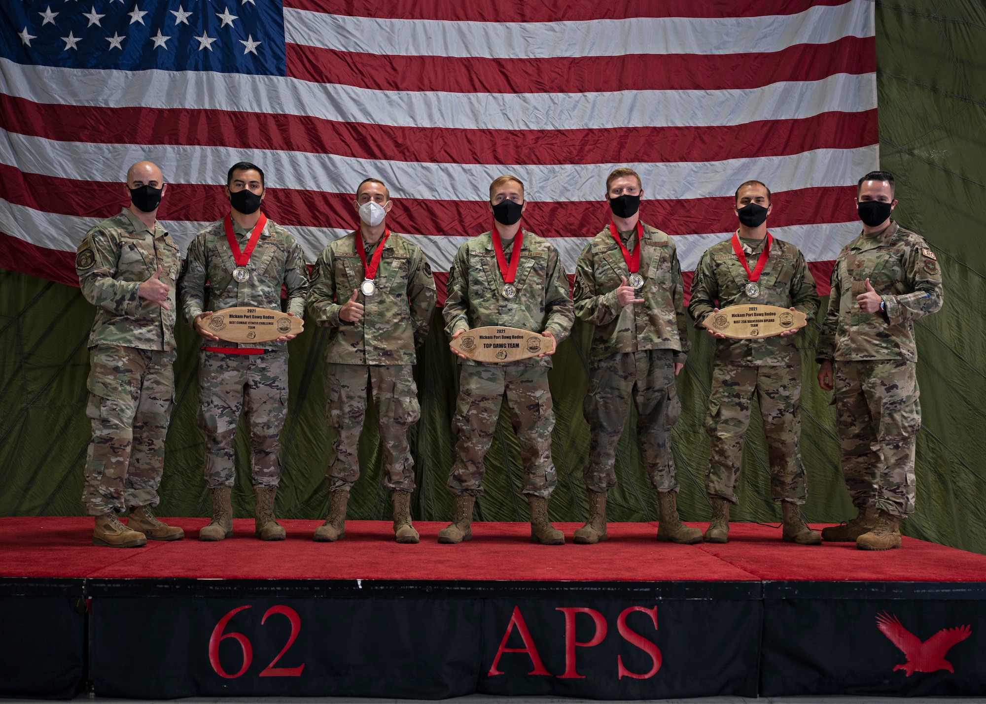 The Eagle Port Rodeo team with the 62nd Aerial Port Squadron receive their awards for winning two events and the title of Top Port Dawg Team at the 2021 Pacific Air Forces (PACAF) Port Dawg Rodeo at Joint Base Lewis-McChord, Washington, Sept. 15, 2021. The team traveled to Joint Base Pearl Harbor-Hickam, Hawaii, for the competition, which included everyday tasks of an aerial port Airman and used to showcase skill and build esprit de corps amongst Port Dawgs. (U.S. Air Force photo by Senior Airman Zoe Thacker)