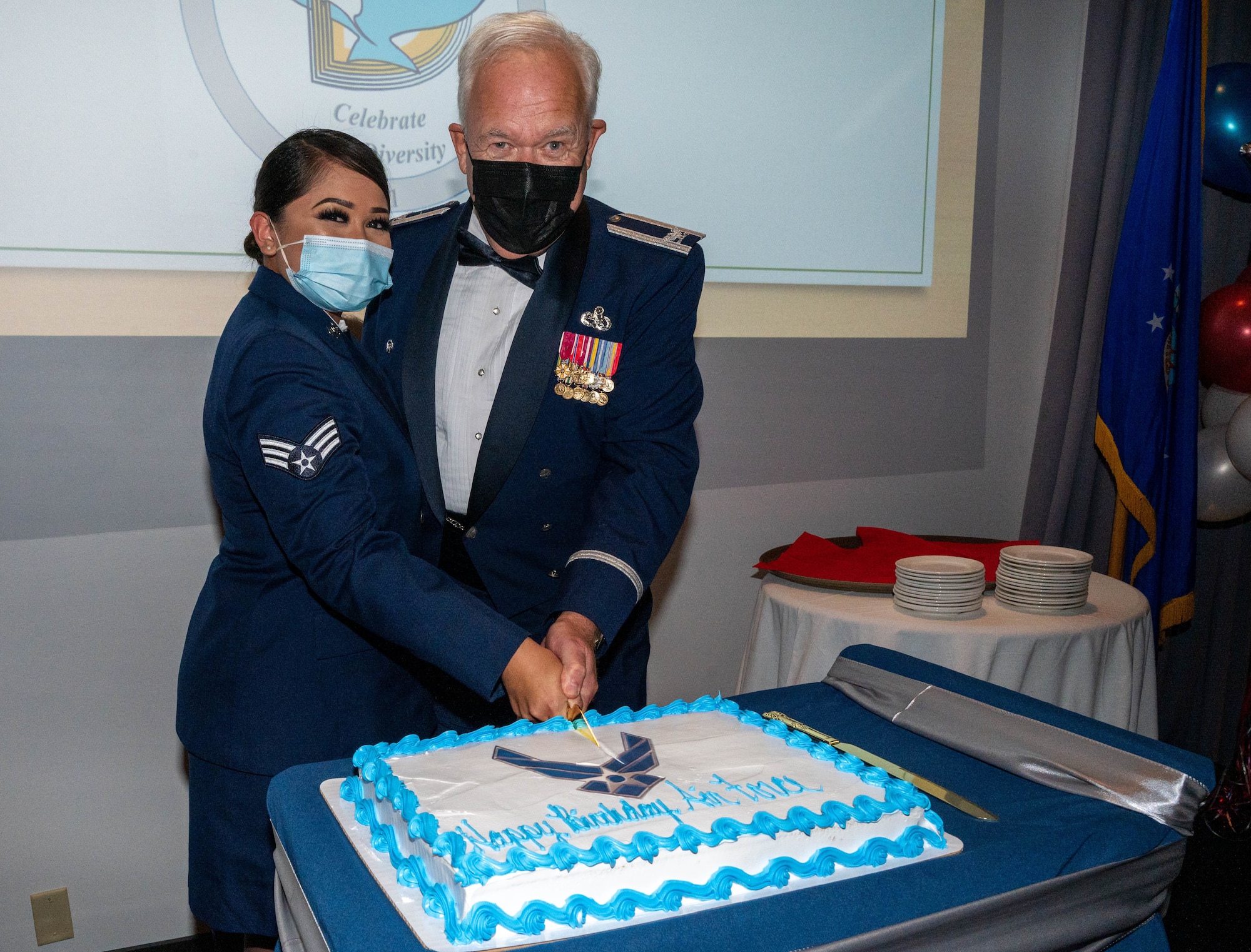 Senior Airman Chanelle Cabanayan, 436th Aerial Port Squadron administrative journeyman and retired Col. James Weber cut the Air Force’s 74th birthday cake at Dover Air Force Base, Delaware, Sept. 18, 2021. Traditionally, the youngest and oldest Airmen at the Air Force Ball cut the cake to celebrate the Air Force birthday. (U.S. Air Force photo by Senior Airman Faith Schaefer)