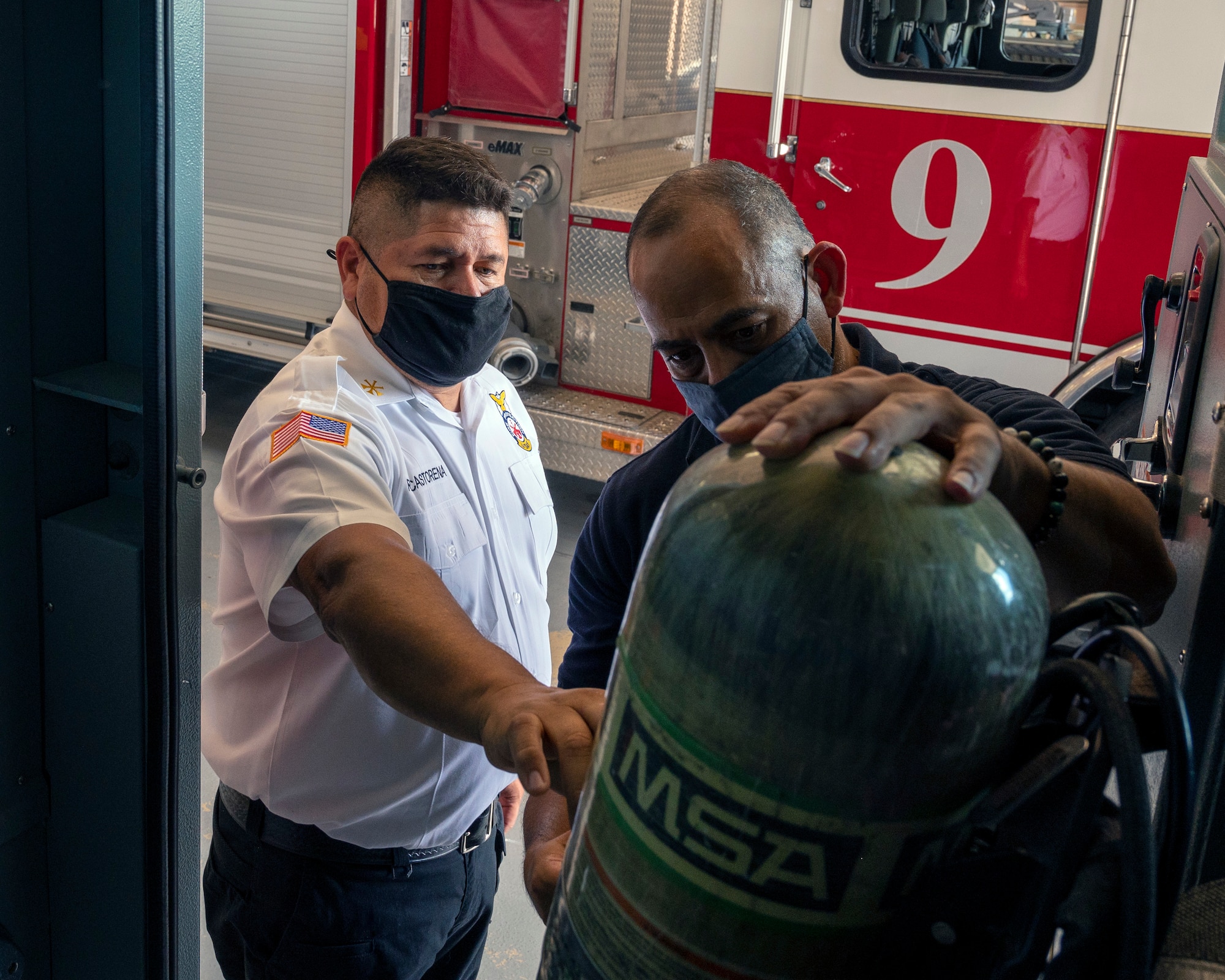 Raul Castorena, 47th Civil Engineering Squadron assistant fire chief, inspects an air canister with Francisco Grijalva, 47th CES Lead Firefighter, on August 25, 2021 at Laughlin Air Force Base, Texas. Safety inspections are essential to keep equipment functioning when they are needed to save lives. (U.S. Air Force Photo by Senior Airman Nicholas Larsen)