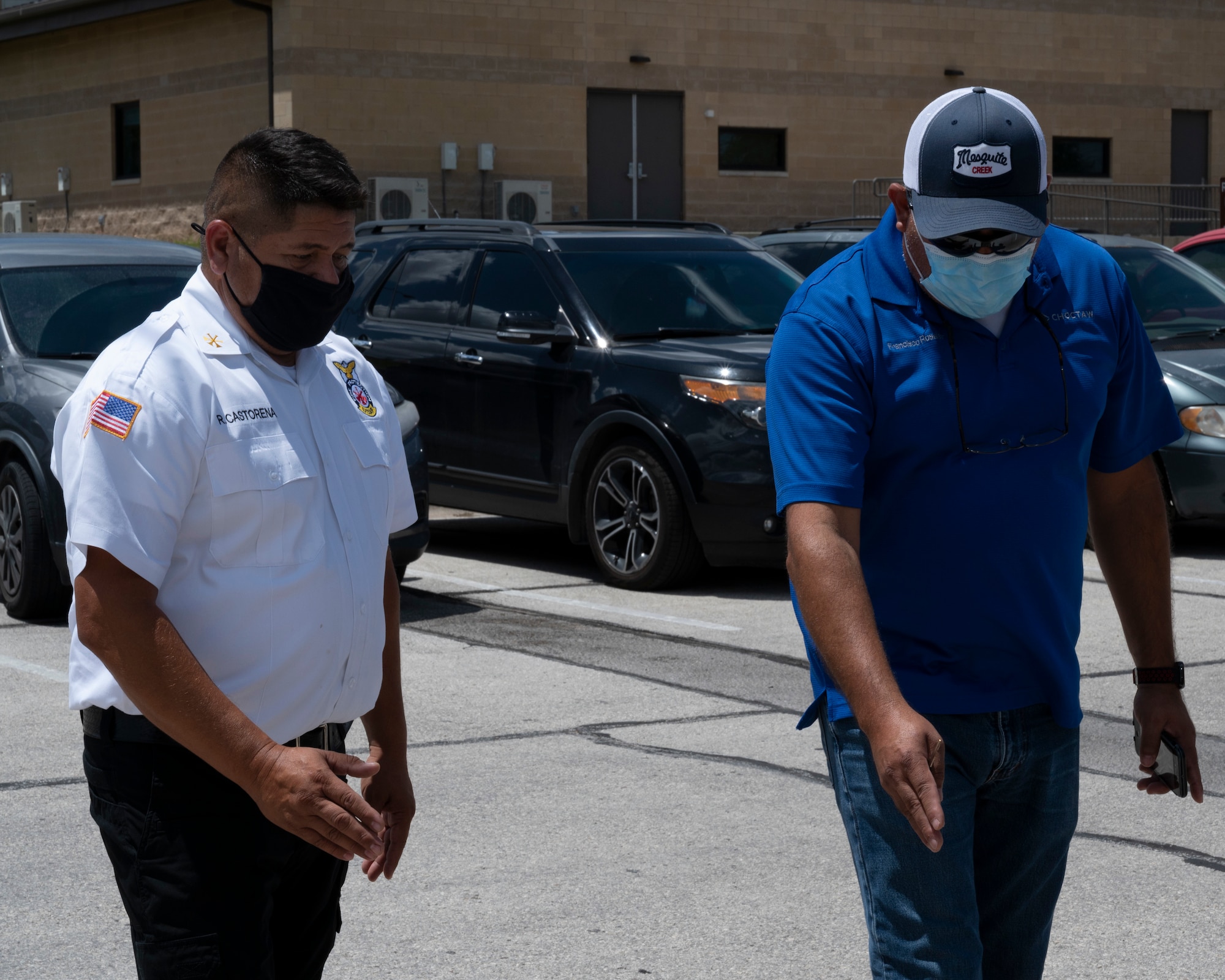 Raul Castorena, 47th Civil Engineering Squadron assistant fire chief, talks with a contractor about painting new lines outside of the Laughlin Air Force Base firestation on August 25, 2021. The lines to be painted will help improve safety and parking outside of the firestation. (U.S. Air Force Photo by Senior Airman Nicholas Larsen)