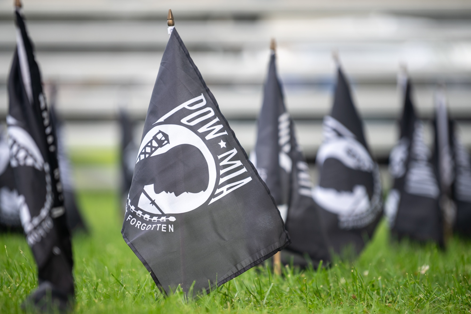 Rows of POW/MIA flags are planted in formation for a retreat ceremony commemorating National POW/MIA Recognition Day on Dover Air Force Base, Delaware, Sept. 17, 2021. The flags represented the 82,000 U.S. military service members still missing in action. (U.S. Air Force photo by Mauricio Campino)