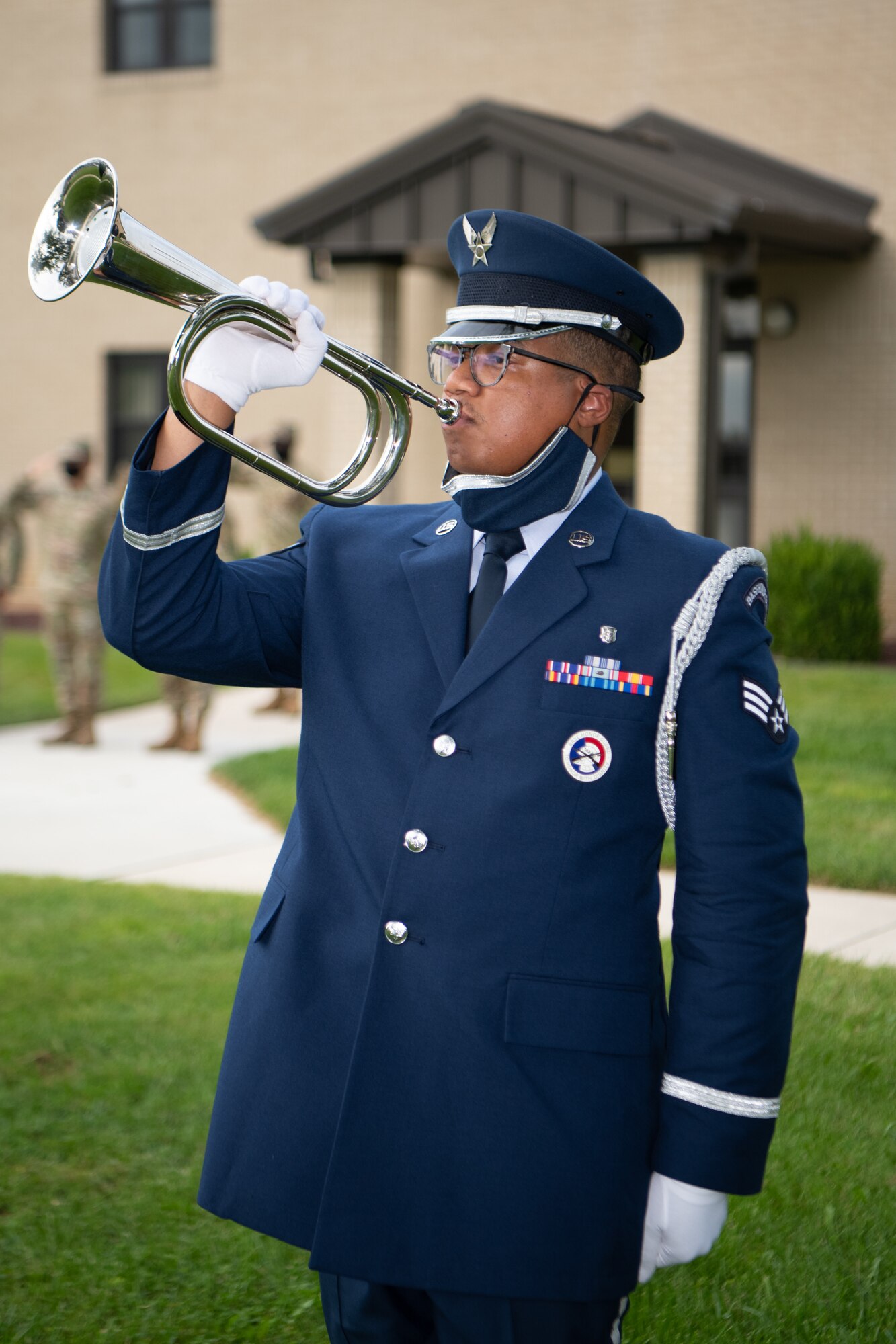 Senior Airman Robert Shedrick, Dover Air Force Base Honor Guard member, plays taps during a retreat ceremony commemorating National POW/MIA Recognition Day on Dover AFB, Delaware, Sept. 17, 2021. Taps is a bugle call played during flag ceremonies and military funerals. (U.S. Air Force photo by Mauricio Campino)