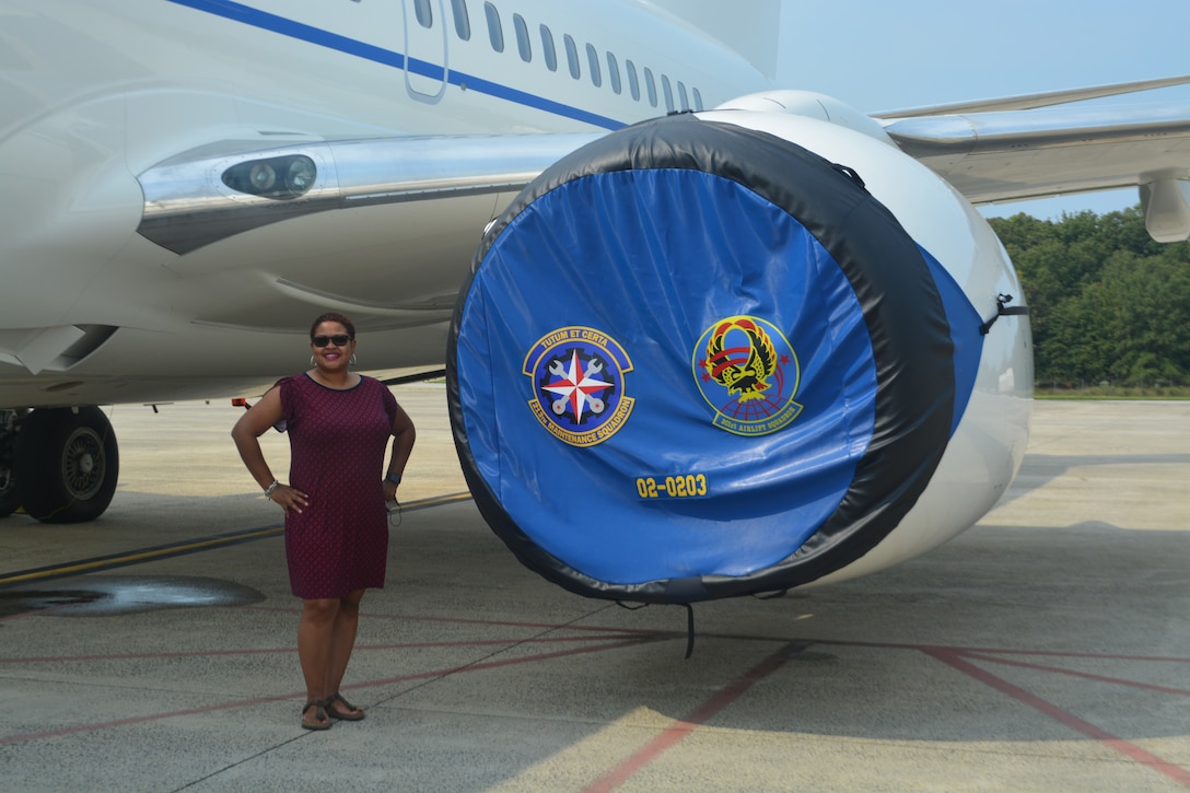 Dr. Tameka Woodruff, Oxon Hill High School’s science and technology program coordinator, poses in front of a 201st Airlift Squadron C-40 after touring the aircraft during the Honorary Commanders Program quarterly visit at JBA, Md., Sept. 14, 2021.